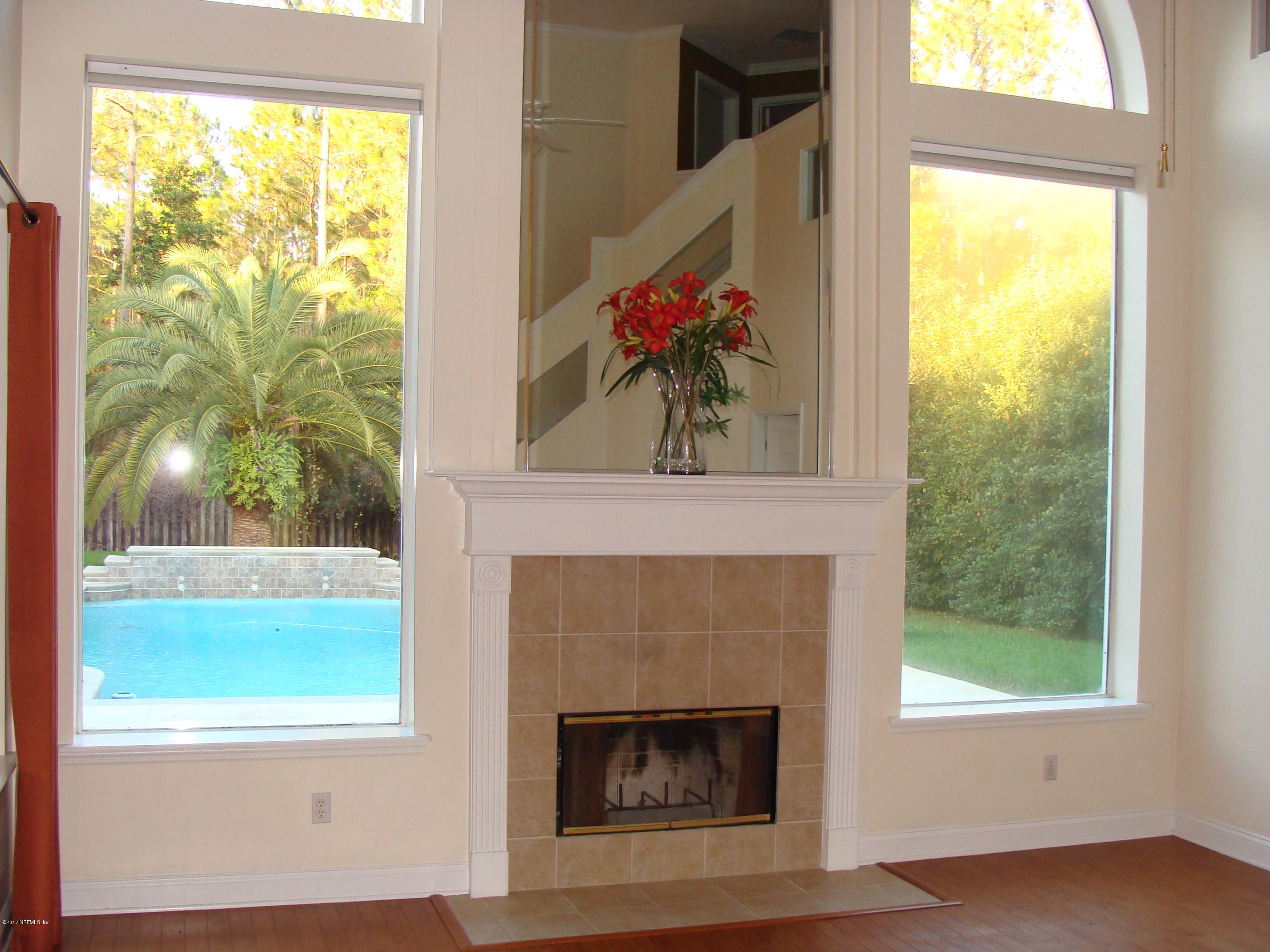 632 Pelham Road St. Augustine, FL 32092 - Photo 3 of 24 a living room with a fireplace and a window