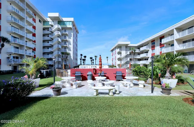 a view of a building with garden and sitting area