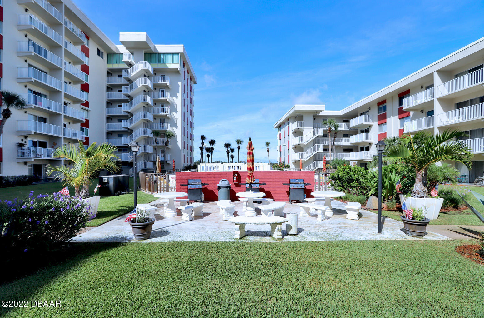 2711 North Halifax Avenue, Unit 282 Daytona Beach, FL 32118 - Photo 14 of 18 a view of a building with garden and sitting area