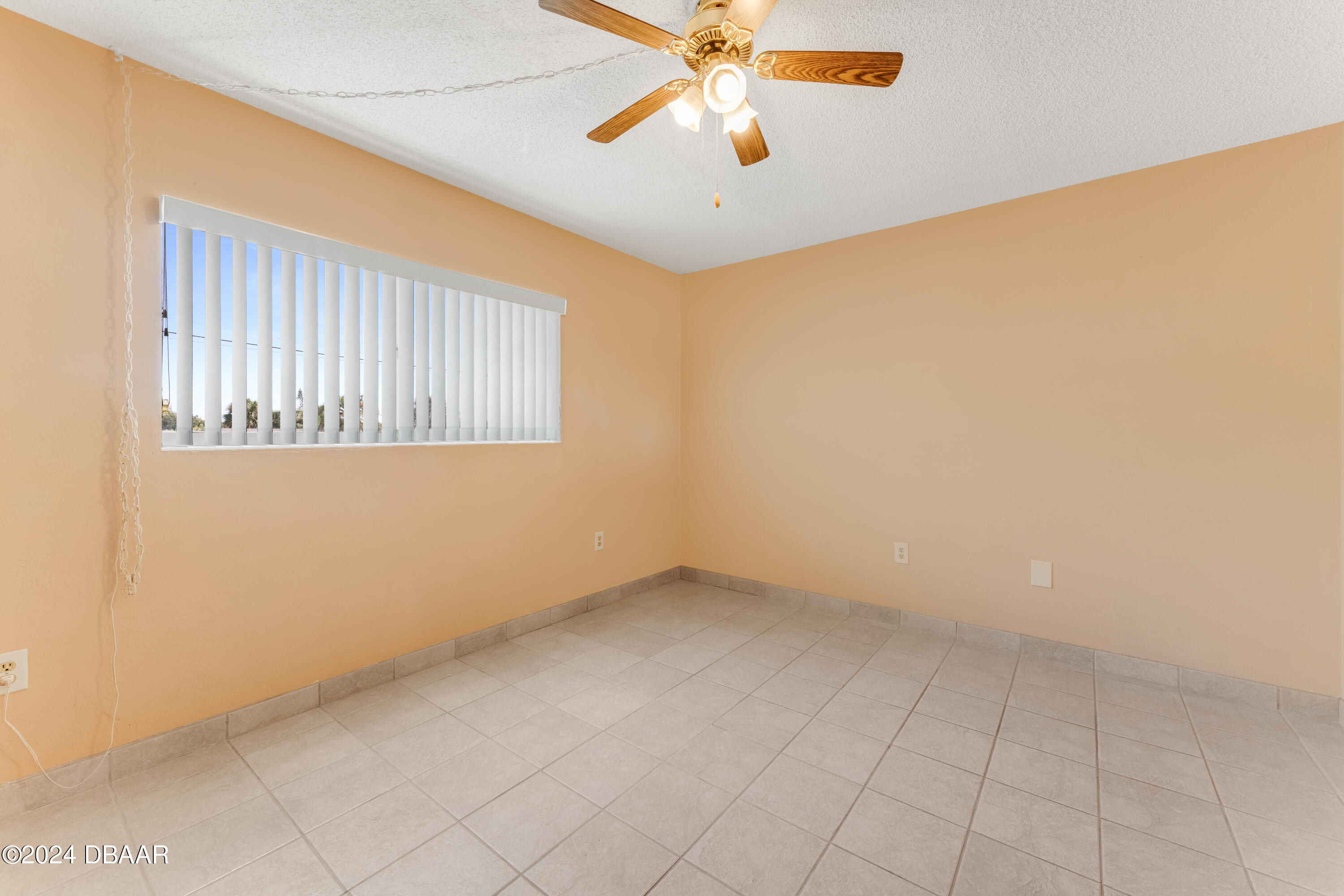 2711 North Halifax Avenue, Unit 282 Daytona Beach, FL 32118 - Photo 8 of 18 an empty room with a ceiling fan and a window