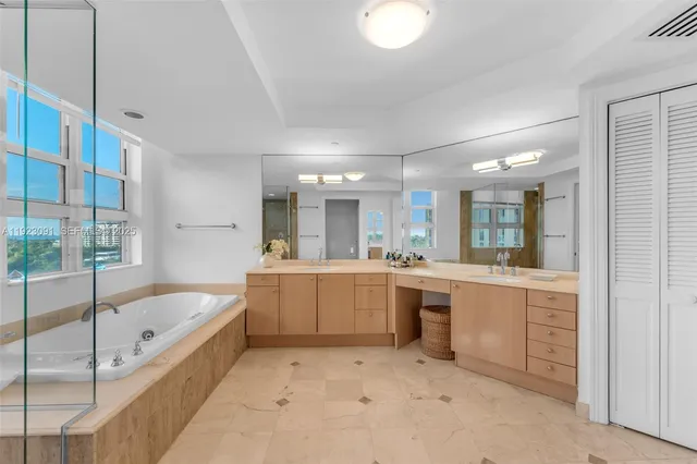 a spacious bathroom with a bathtub and a shower