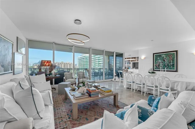 a living room with furniture and large windows