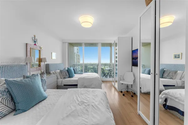 a bedroom with two beds and a book shelf