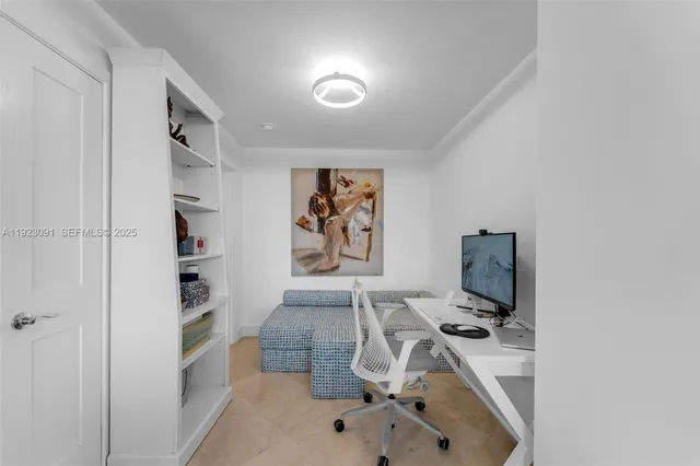 a view of a hallway with furniture and a potted plant