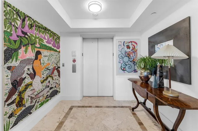 a balcony with table and chairs and potted plants