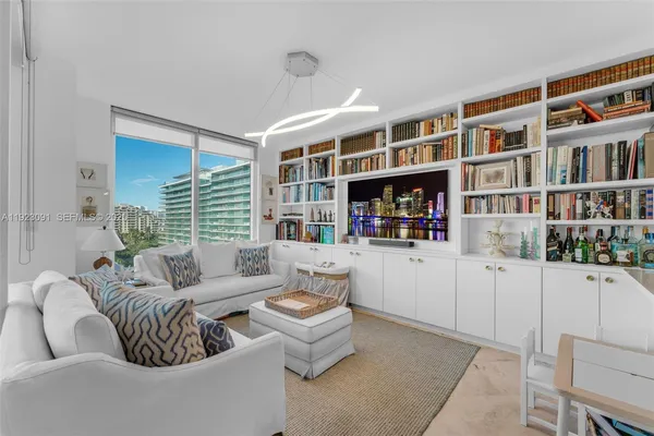 a living room with furniture and a book shelf