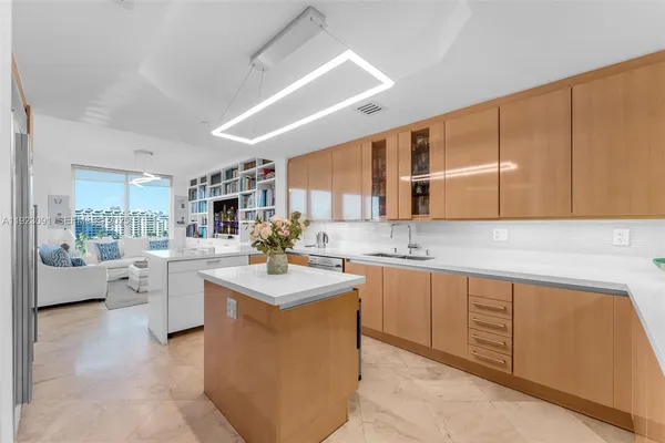 a kitchen with stainless steel appliances granite countertop a sink and a white cabinets