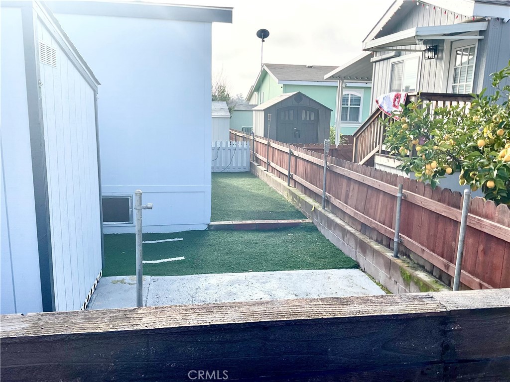 6154 South Walnut Street, Unit 40 Loomis, CA 95650 - Photo 14 of 15 a view of wooden house and a yard with potted plants