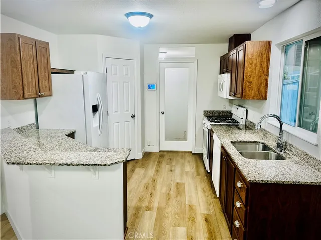 a kitchen with a sink stove and a refrigerator