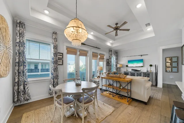 a view of a dining room with furniture wooden floor and chandelier