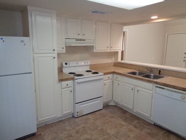701 Foster Drive, Unit 4 Conroe, TX 77301 - Photo 5 of 11 a kitchen with cabinets appliances and a sink