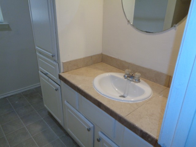 701 Foster Drive, Unit 4 Conroe, TX 77301 - Photo 9 of 11 a bathroom with a sink and a mirror