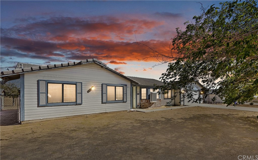 16539 Mesquite Road Apple Valley, CA 92307 - Photo 1 of 1 a front view of a house with a yard and garage