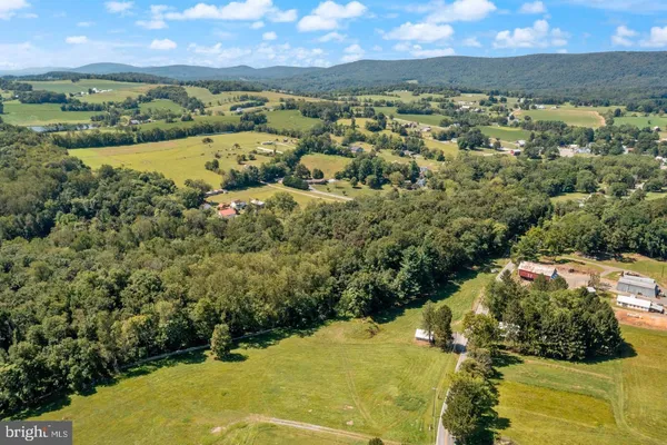 an aerial view of a houses with a yard