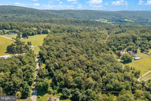 a view of a field with an ocean and mountain view