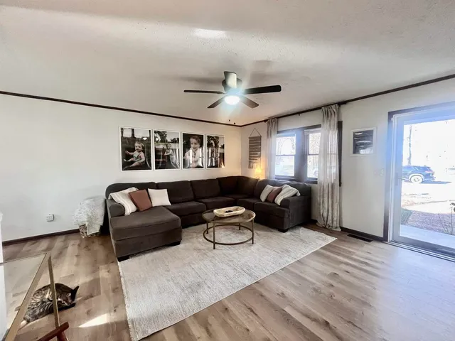 a living room with furniture and a chandelier
