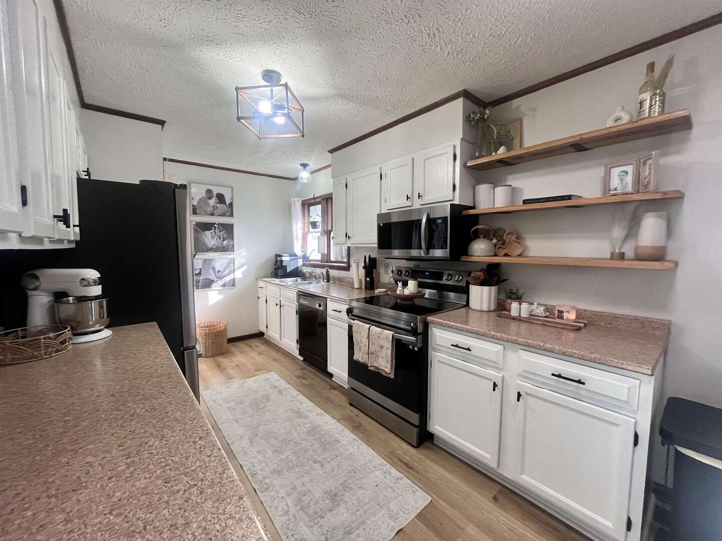 212 East 19th Street Metropolis, IL 62960 - Photo 16 of 30 a kitchen with stainless steel appliances a stove refrigerator sink and microwave