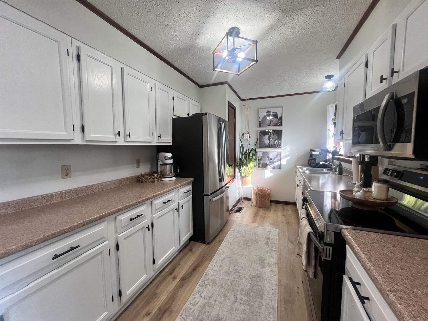 212 East 19th Street Metropolis, IL 62960 - Photo 17 of 30 a kitchen with stainless steel appliances granite countertop a refrigerator stove microwave and sink