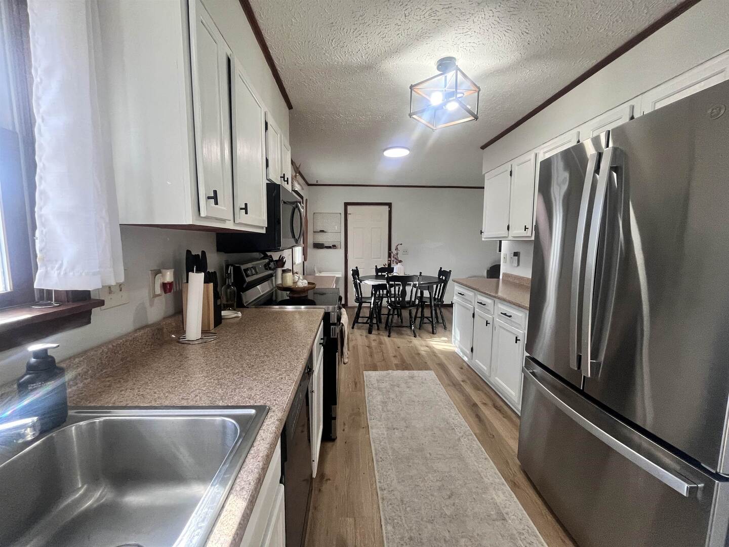 212 East 19th Street Metropolis, IL 62960 - Photo 18 of 30 a kitchen with stainless steel appliances granite countertop a refrigerator a stove and a sink with cabinets