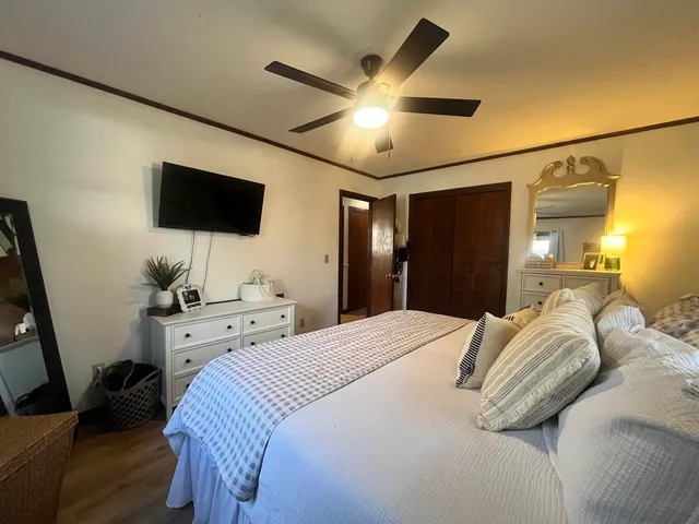 a bedroom with a bed and a flat screen tv