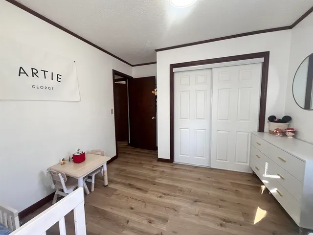 a room with furniture and wooden floor