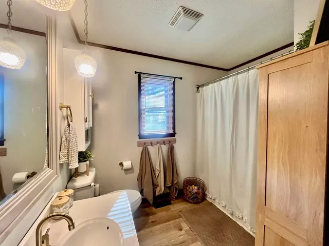 a bathroom with a sink a mirror and a shower