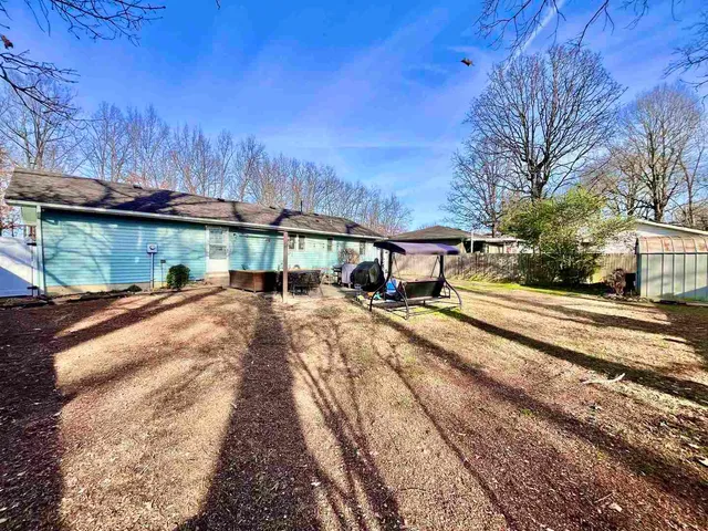 a view of a house with large trees
