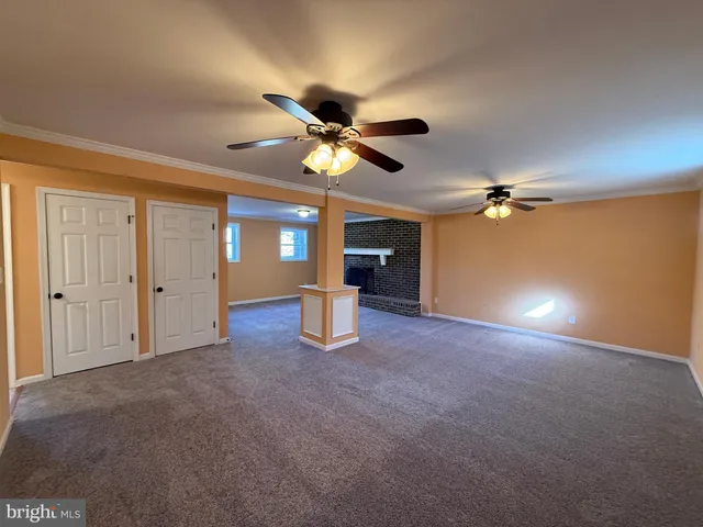a view of a livingroom with a ceiling fan and window