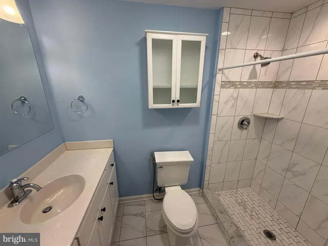 a white toilet sitting next to a bathroom sink