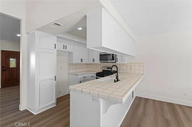 a view of a kitchen with electric appliances