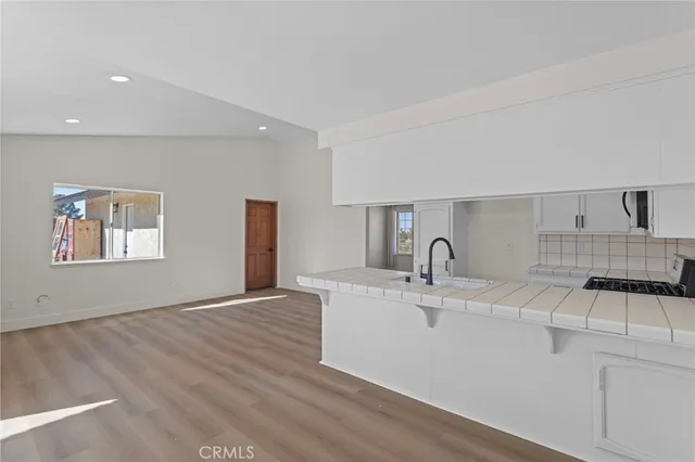 a view of a kitchen with a sink cabinet and a window