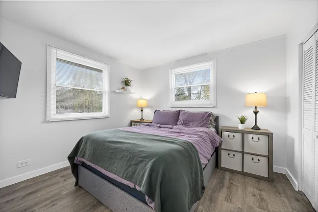 a bedroom with a bed and a night stand