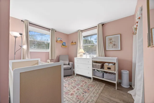 a bathroom with a sink a toilet a mirror and shower curtain