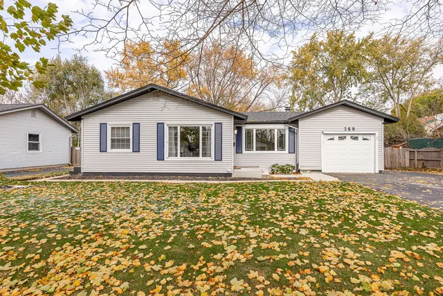 a backyard of a house with table and chairs