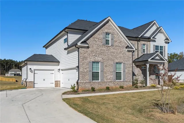 a front view of a house with a yard