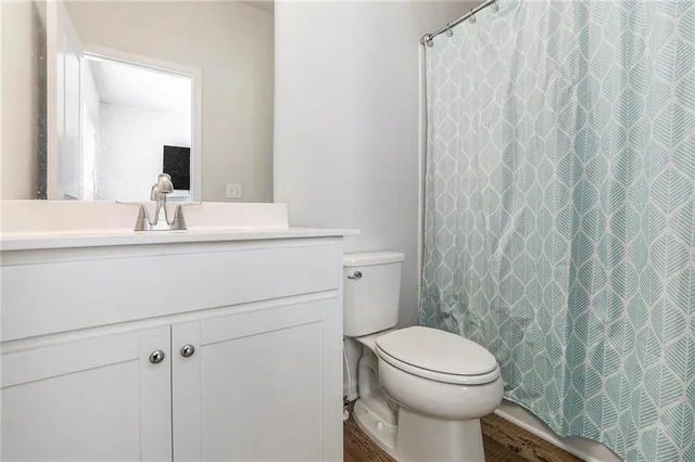a bathroom with a sink a toilet and a mirror