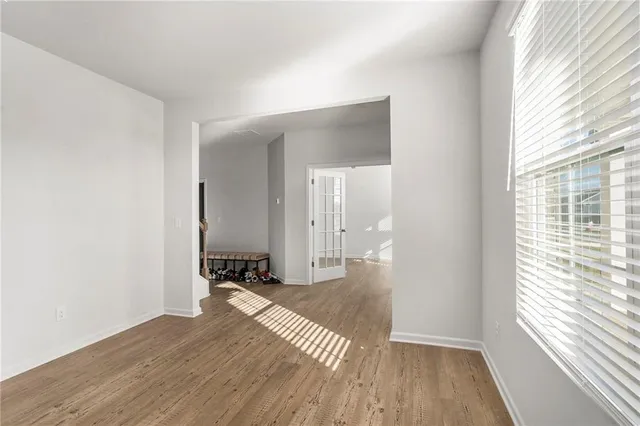 a view of a room with wooden floor and a window