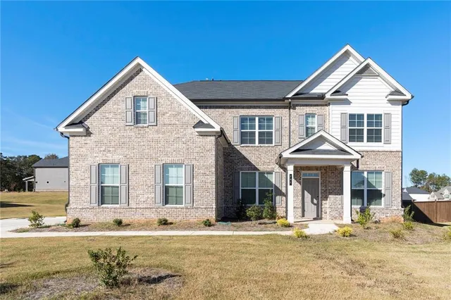 a front view of a house with a yard
