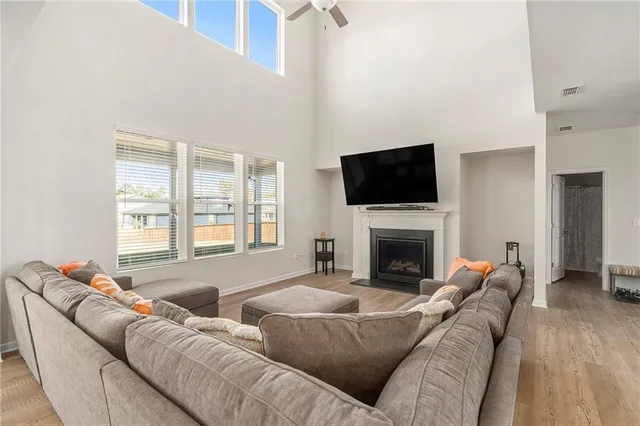 a living room with furniture a fireplace and a flat screen tv