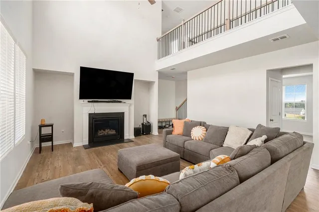 a living room with furniture a flat screen tv and a fireplace