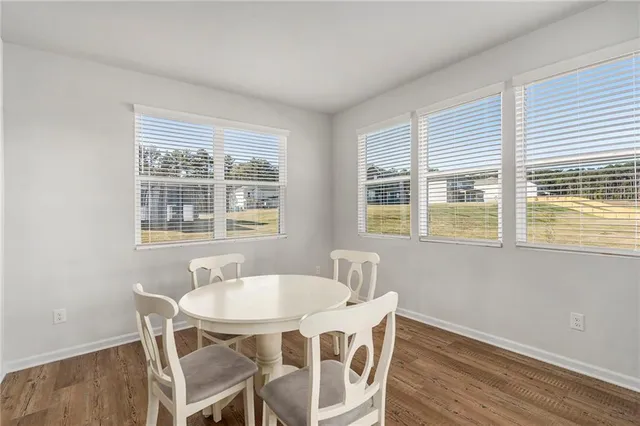 a dining room with furniture and windows