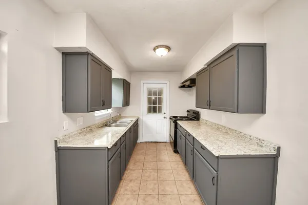 a large bathroom with a granite countertop double vanity sink and a bathtub