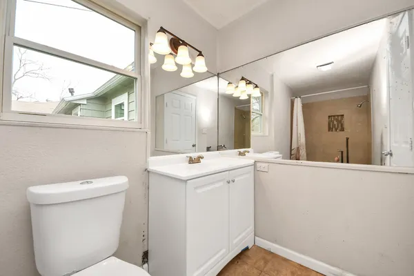 a view of bathroom with a toilet sink and mirror