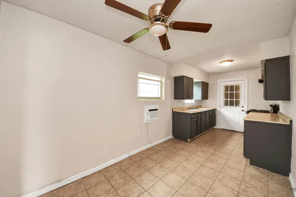 a large white kitchen with a sink stainless steel appliances and cabinets