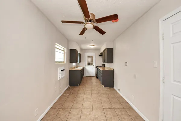 a view of a kitchen with kitchen island wooden floor center island and stainless steel appliances