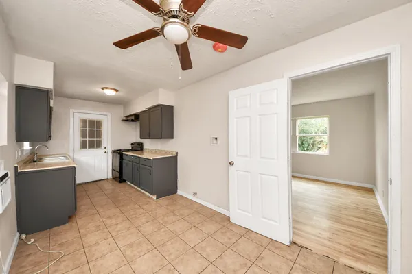 a view of a kitchen with furniture and wooden floor