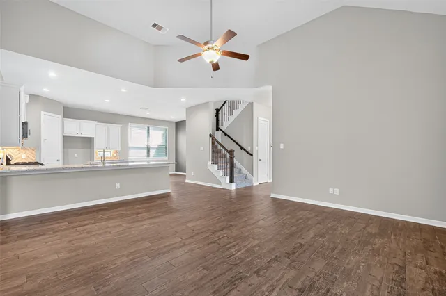 a living room with furniture and a flat screen tv with wooden floor
