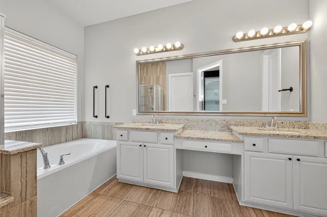 a bathroom with a granite countertop sink a large mirror and a