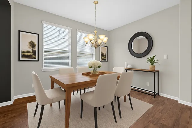 a dining room with furniture a window and wooden floor