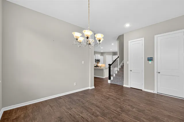 a view of a chandelier in big room and chandelier fan